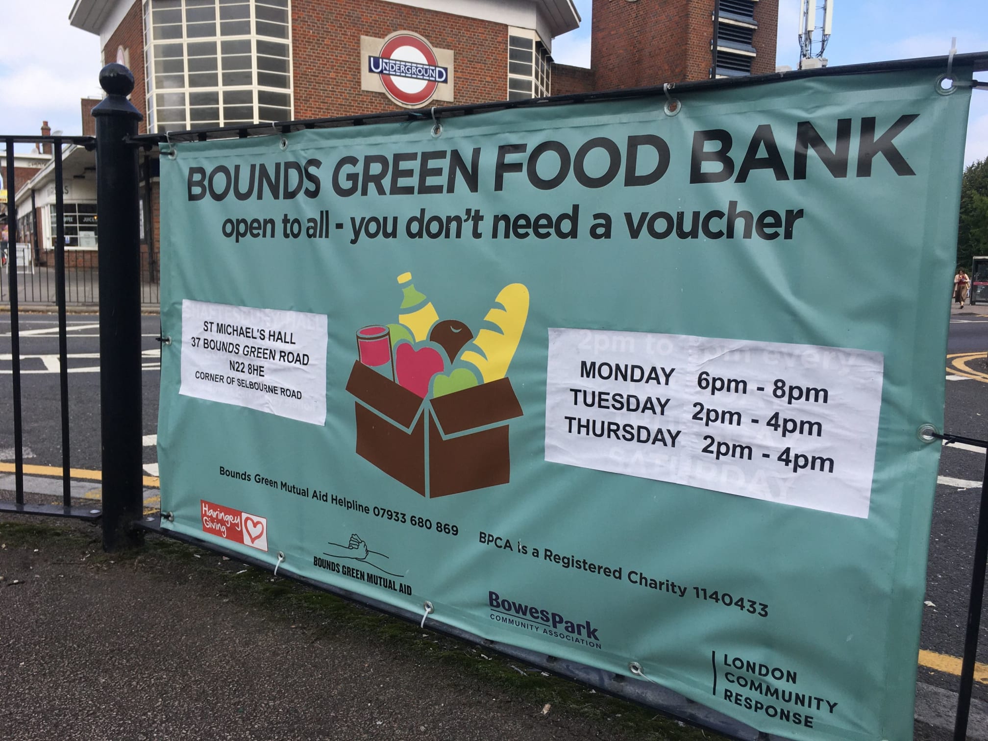 Bounds Green Food Bank banner with opening times at the entrance to the Food Bank